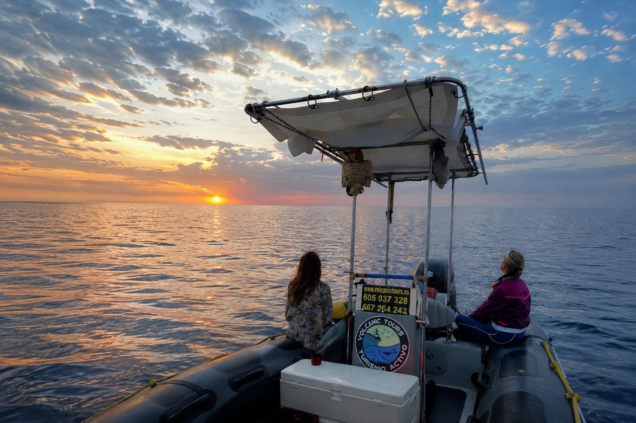 Embarcación de Volcanic Tours al atardecer en el mar
